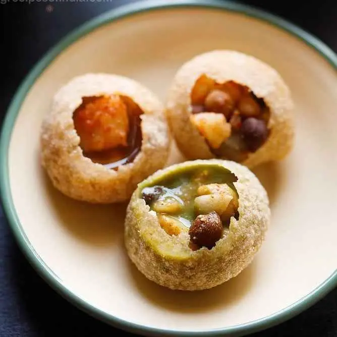 Crispy golgappe filled with spicy mint water, tamarind chutney, and potatoes