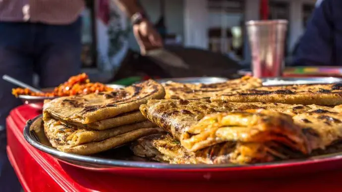 Delhi stuffed paranthas with potato, paneer, or cauliflower served with curd