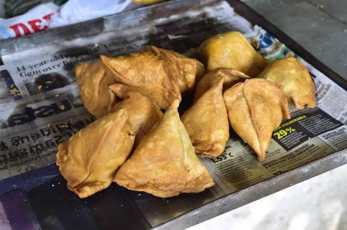 Crispy samosas and kachoris stuffed with spiced potatoes, peas, or lentils