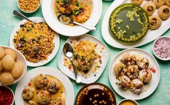 Delhi street food scene with vibrant stalls and popular dishes like chole bhature and chaats